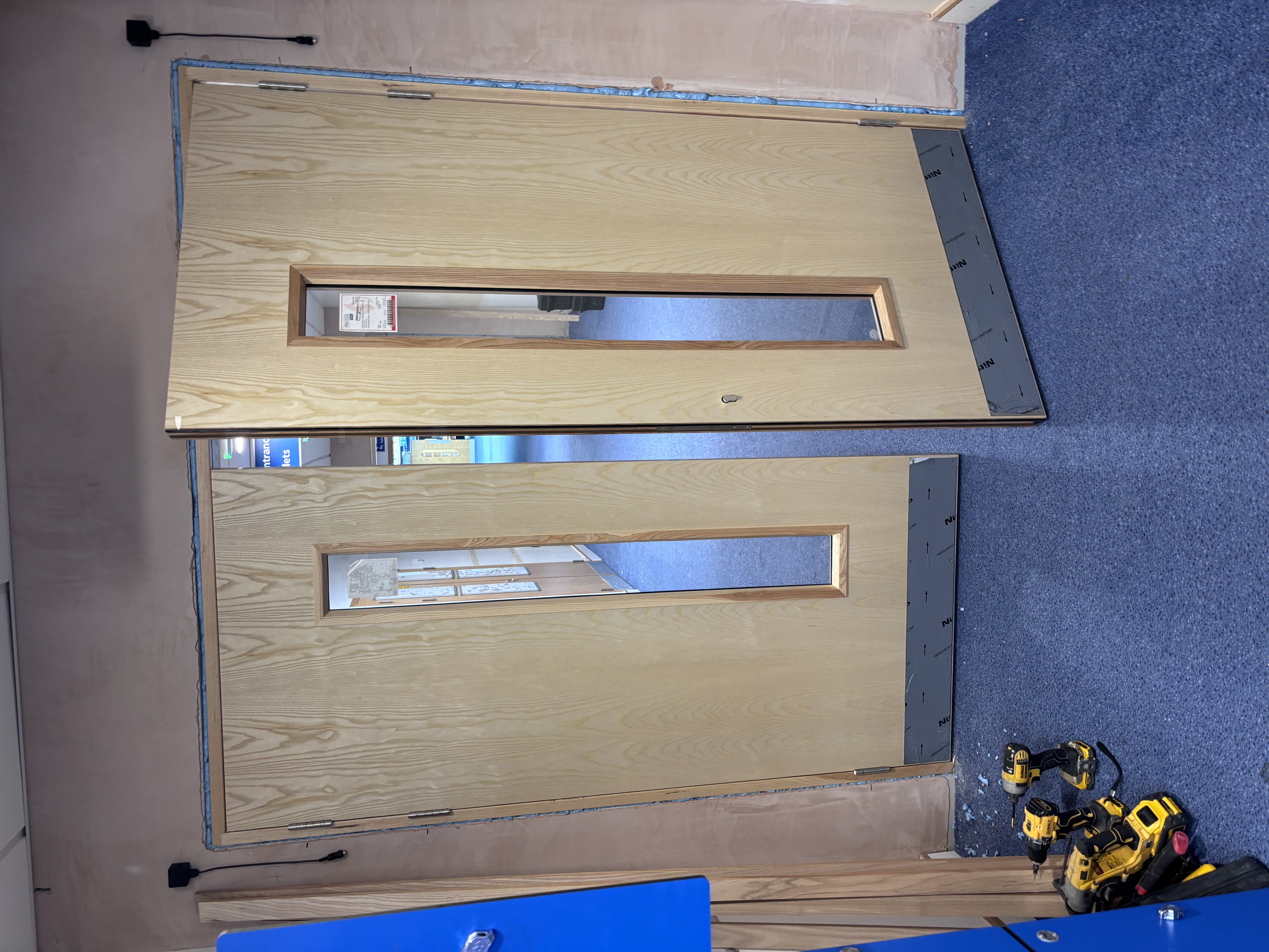 Oak vision panel double doors being installed